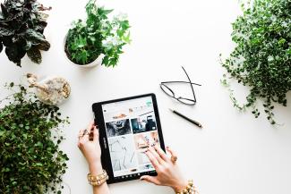 person using black tablet computer by Brooke Lark courtesy of Unsplash.
