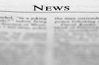 A news paper with the word news on it by John Cardamone courtesy of Unsplash.