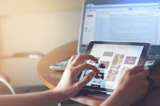 person holding black iPad by Taras Shypka courtesy of Unsplash.