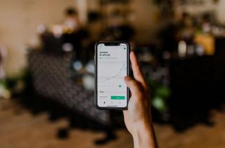 person holding black iPhone displaying stock exchange by Austin Distel courtesy of Unsplash.