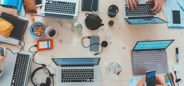 people sitting down near table with assorted laptop computers by Marvin Meyer courtesy of Unsplash.
