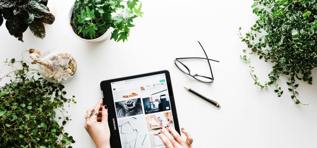 person using black tablet computer by Brooke Lark courtesy of Unsplash.