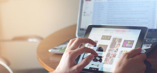 person holding black iPad by Taras Shypka courtesy of Unsplash.